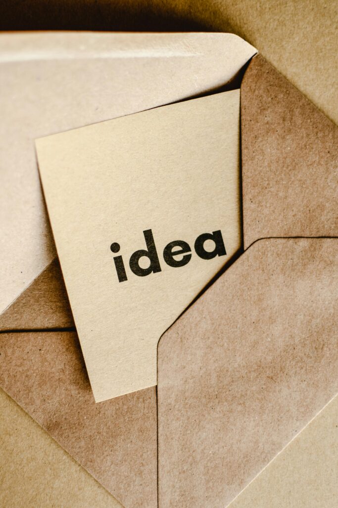 A close-up of a brown envelope containing a card labeled 'idea,' symbolizing creativity and innovation.